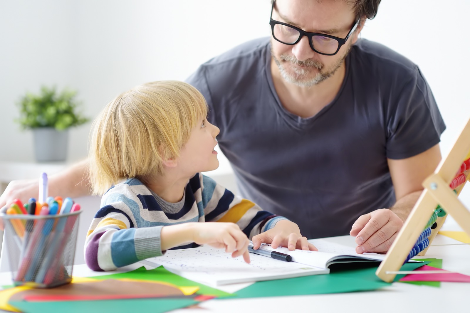 Tutor teaching boy with dyslexia.